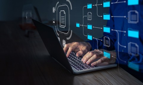 Man with a laptop managing corporate files and information