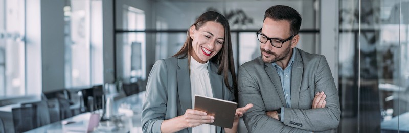 Two coworkers having a discussion in modern office
